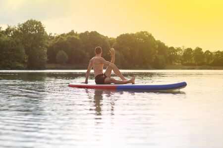 stand up paddling SUP back doing yoga