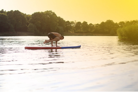 SUP Yoga at a stand up paddling boardの写真素材