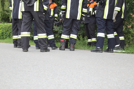A Team of Firefighters discussing pausing just Feetの写真素材