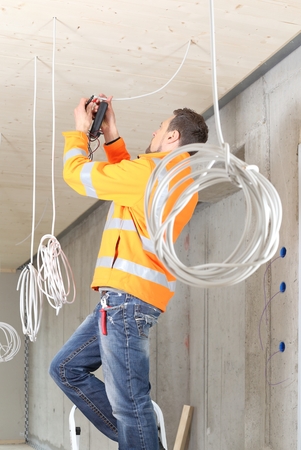A  Electrician working in New building with cablesの写真素材