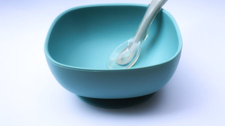 Blue color baby plate and spoon made from silicone, safety for baby for daily meal start from 6 month age.の写真素材