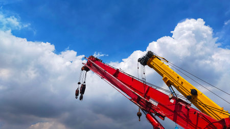 Beautiful red and yellow telescopic crane with blue sky with cloud for background.の写真素材