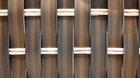 Knitted synthetic rattan material with traditional brown and white texture for wallpaper and...