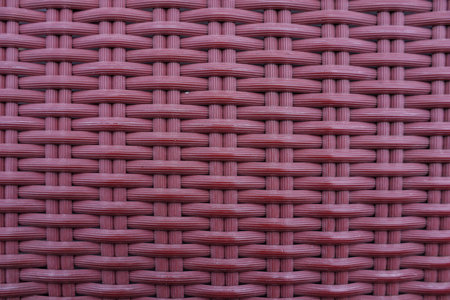 Knitted synthetic rattan material with traditional red cross texture for wallpaper and background.の写真素材