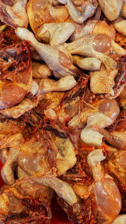 Chicken leg meat at the butcher shop display in traditional market. Raw meat.の写真素材