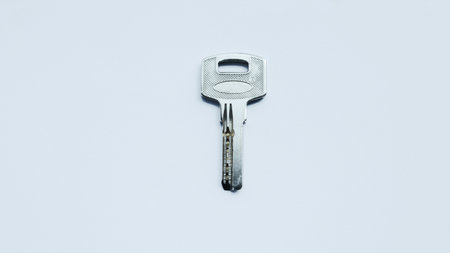 Silver metallic key isolated on white.