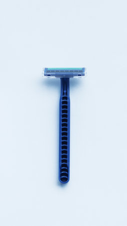 Disposable blue plastic shaver isolated on white.の写真素材