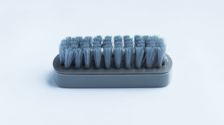 Multifunctional gray scrub plastic brush isolated on white background.