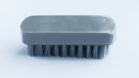 Multifunctional gray scrub plastic brush isolated on white background.の写真素材
