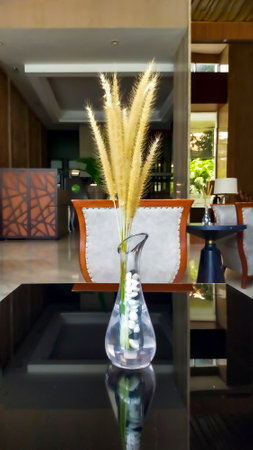 Dried Pampas Grass Phragmites Reed Flower in the glass vase at the table.の写真素材