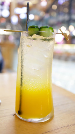 Tropical blush mocktail sweet and fresh drink with assorted tropical fruit mango and orange and soda.の写真素材