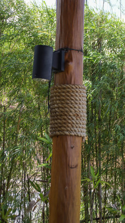 An authentic wooden pillar with rope for decoration rustic look also traditional with additional spotlight.の写真素材
