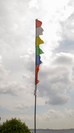 Common colorful festival flag or event flag, or banner flag, or games flag with cloudy blue sky background.の写真素材