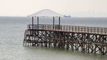 Wooden bridge dock or pier or boardwalk jetty for ship to dock at the shore.の写真素材