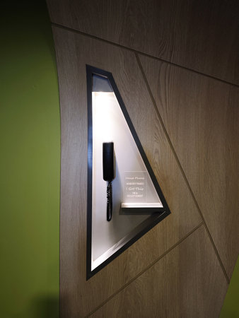 Elegant Wall Phone in Modern Interior Setting Featuring Minimalist Design and Warm Wood Accents at a...