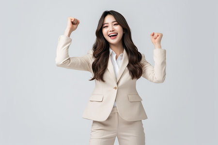Portrait of a happy business woman celebrating success, isolated on white backgroundの素材