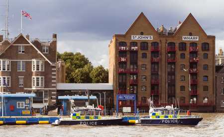 September 2017 - Police boat moored at a pontoon at Thames river near Marine Policing Unit headquarters on Wapping High Street in London, UKのeditorial素材