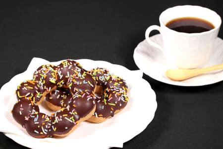 Tasty chocolate donuts and cup of coffeeの写真素材