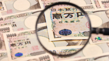 Japanese yen bill and magnifying glassの写真素材