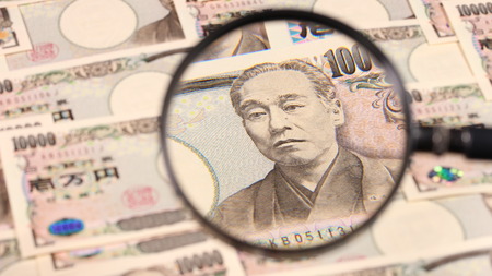 Japanese yen bill and magnifying glassの写真素材