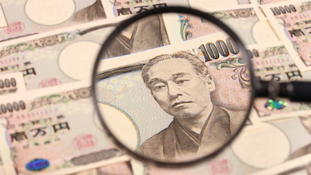 Japanese yen bill and magnifying glassの写真素材