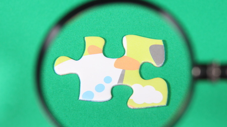Jigsaw puzzle and magnifying glassの写真素材