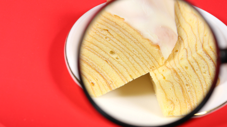 Baumkuchen and magnifying glassの写真素材