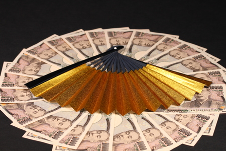 Ten thousand japanese yen bills and japanese fanの写真素材