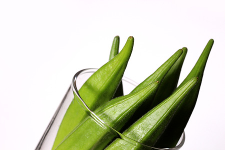 Fresh okra in glass cupの写真素材