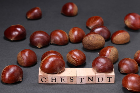 Fresh chestnuts and block with CHESTNUTの写真素材