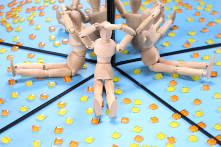 glass block and wooden doll reflecting in the mirrorの写真素材