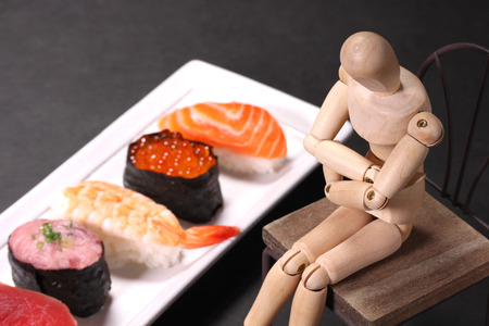 Sushi and wooden dollの写真素材