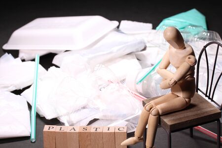 Plastic garbage and wooden doll