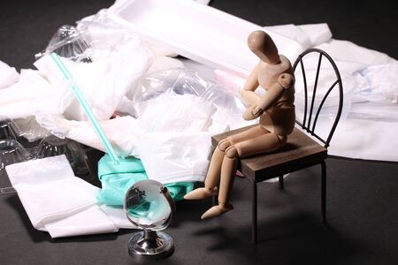 Plastic garbage and wooden doll