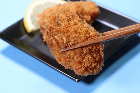 Deep fried oyster with  chopsticks