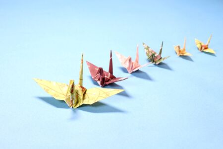 Paper cranes on blue backgroundの写真素材