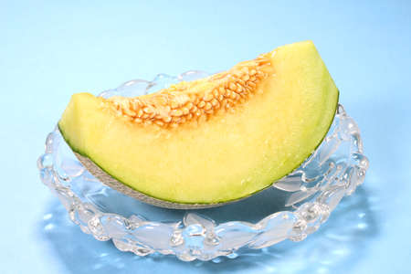 Fresh green melon on a glasswareの写真素材