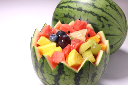 A watermelon filled with fresh fruitsの写真素材