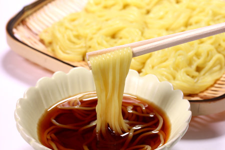 Eating cold ramen noodles with chopsticks