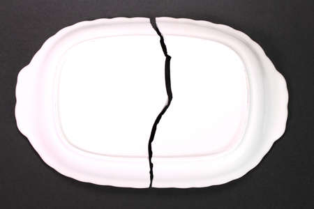 Broken gratin dish on black backgroundの写真素材