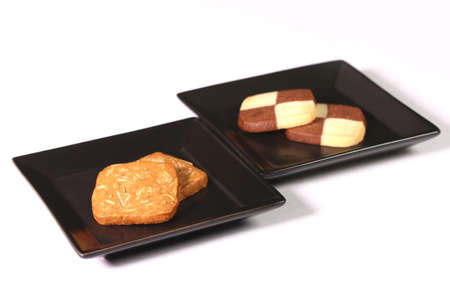 Almond cookies and checkerboard cookies on a plateの写真素材