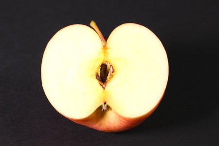 Cross section of red apple on black backgroundの写真素材