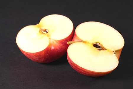 Cross section of red apple on black backgroundの写真素材