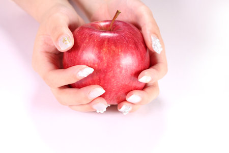 Woman's hands holding an appleの写真素材