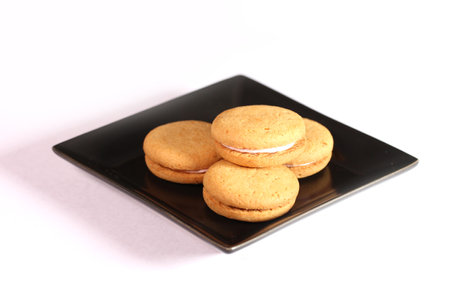 Wheat bran cookies with strawberry cream on a plateの写真素材