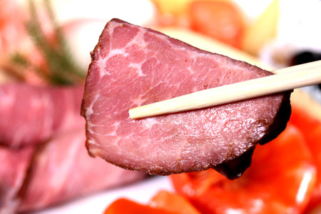 Eating roast beef with chopsticksの写真素材