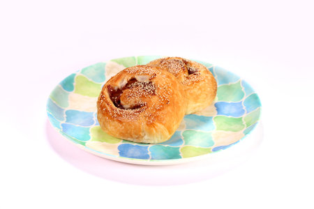 Danish pastry with red bean paste on a plate on white backgroundの写真素材