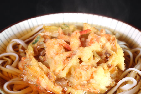 Udon Noodles with shrimp and mix vegetable tempura on black backgroundの写真素材