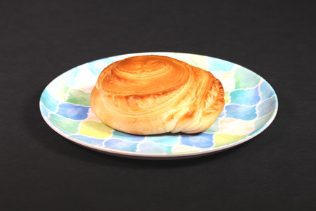 Danish pastry on a plate on black backgroundの写真素材