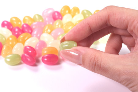 Female hand holding fruit gummyの写真素材